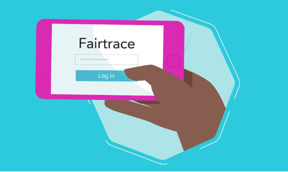 A hand holding a phone with the Fairtrace login page open